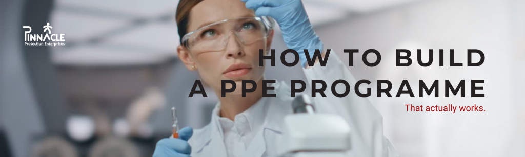 Worker wearing disposable PPE in a laboratory setting.