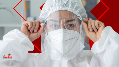Worker wearing disposable PPE in a laboratory setting.
