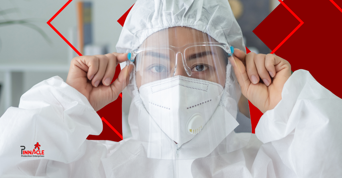 Worker wearing disposable PPE in a laboratory setting.